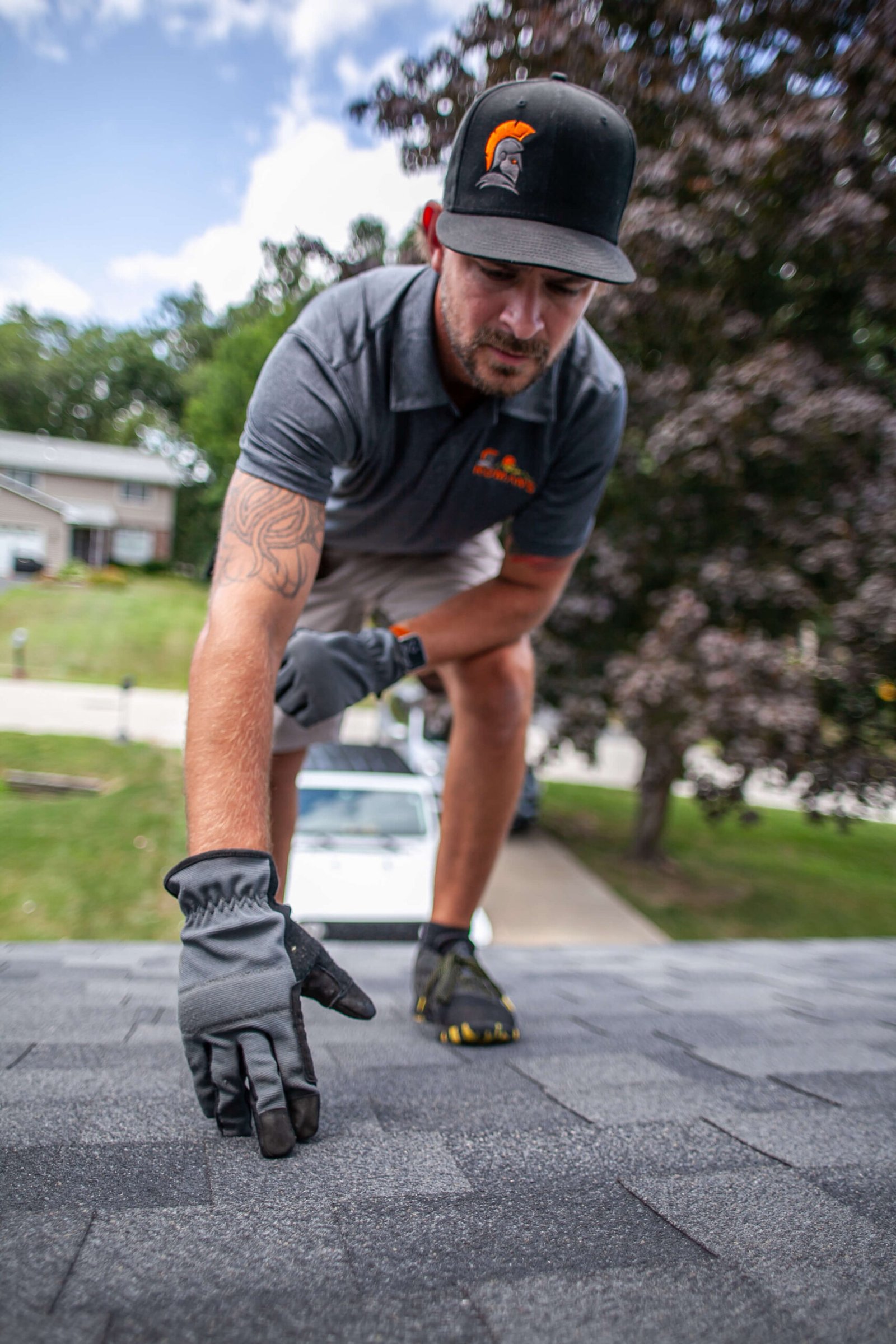 Roman's Roofing Employee working on roof