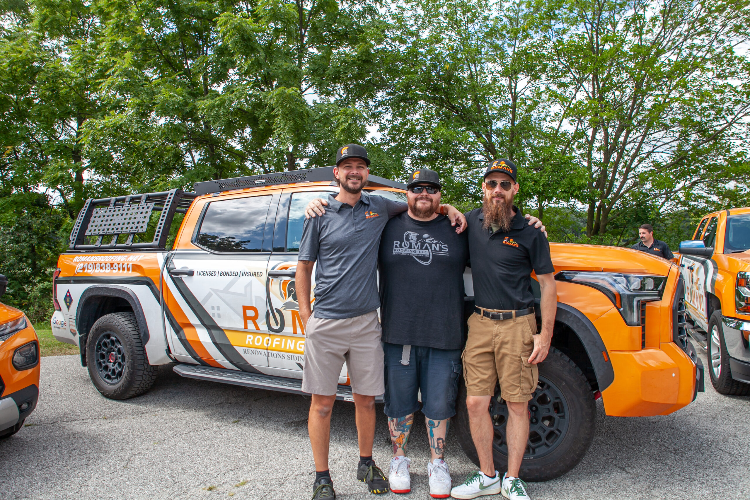Roman's Roofing Team in Front of their Truck